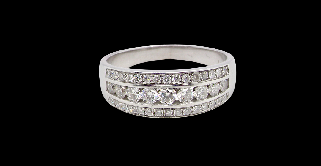 18 carat white gold half hoop ring. Set with a middle row of nine bright white brilliant cut diamonds, graduate from 2.2mm to 2.6mm. The top and bottom rows are also set with small diamonds.