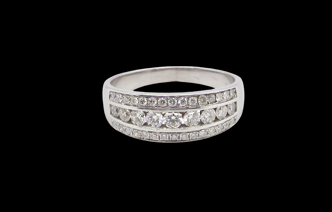 18 carat white gold half hoop ring. Set with a middle row of nine bright white brilliant cut diamonds, graduate from 2.2mm to 2.6mm. The top and bottom rows are also set with small diamonds.