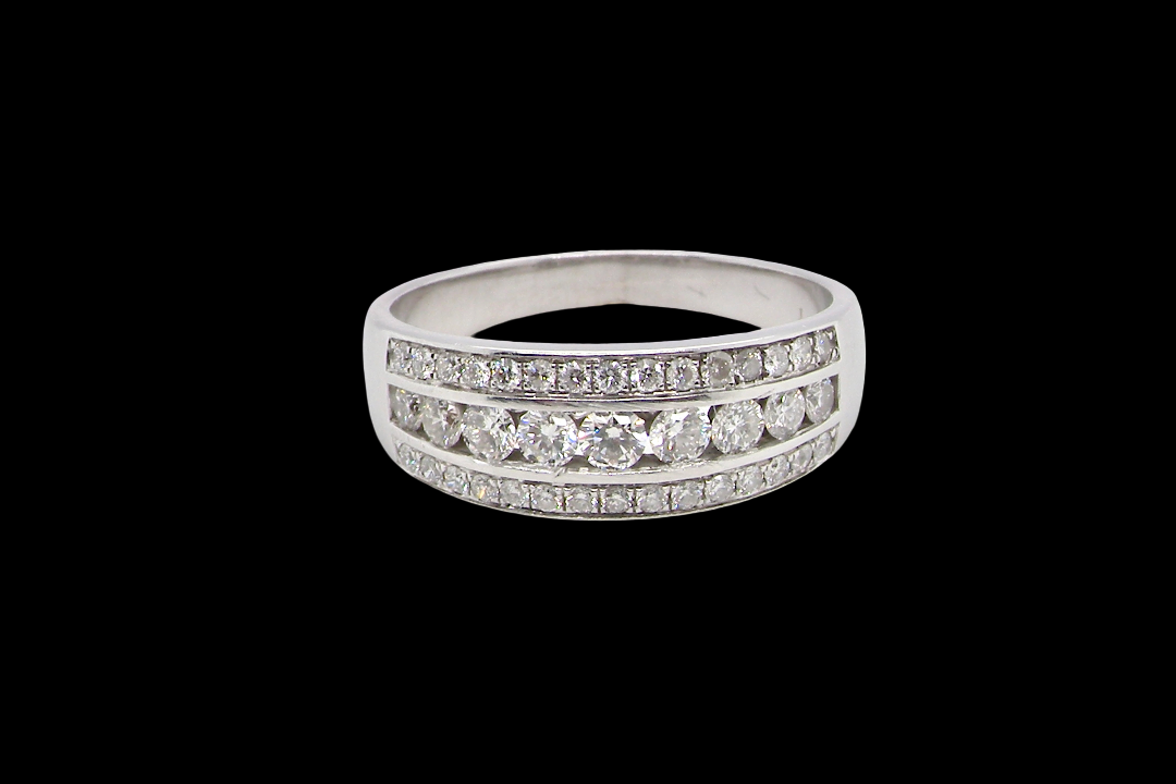18 carat white gold half hoop ring. Set with a middle row of nine bright white brilliant cut diamonds, graduate from 2.2mm to 2.6mm. The top and bottom rows are also set with small diamonds.