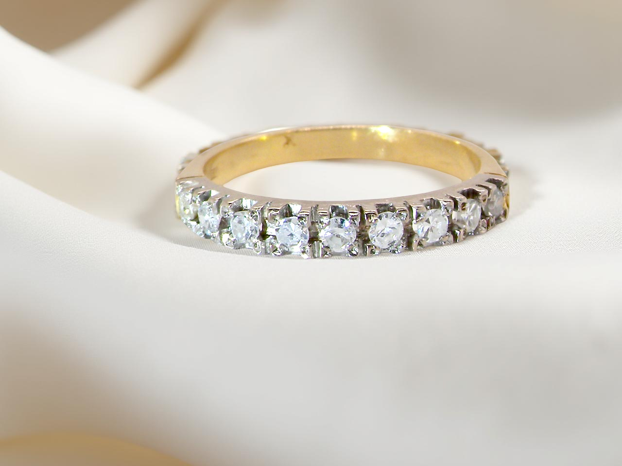 1970s vintage half-hoop eternity ring, tested as 18 carat gold and elegantly set white diamonds.