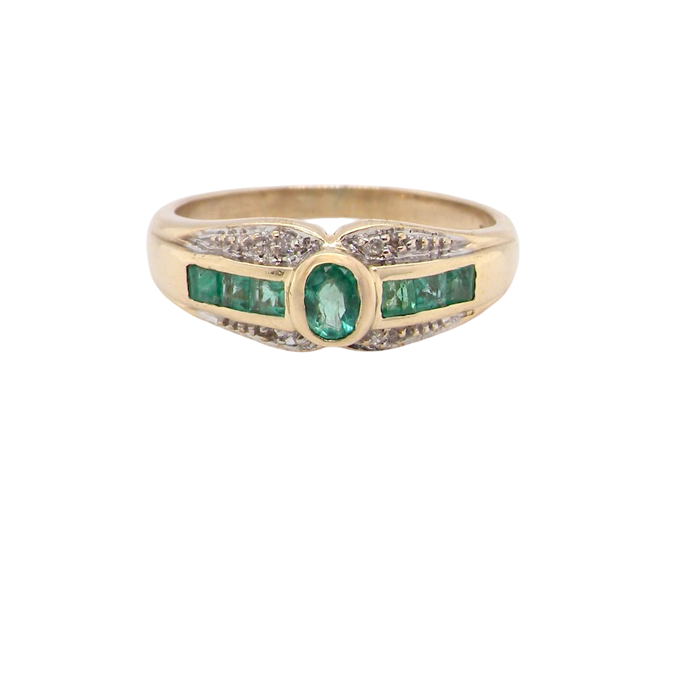 An emerald and diamond dress ring