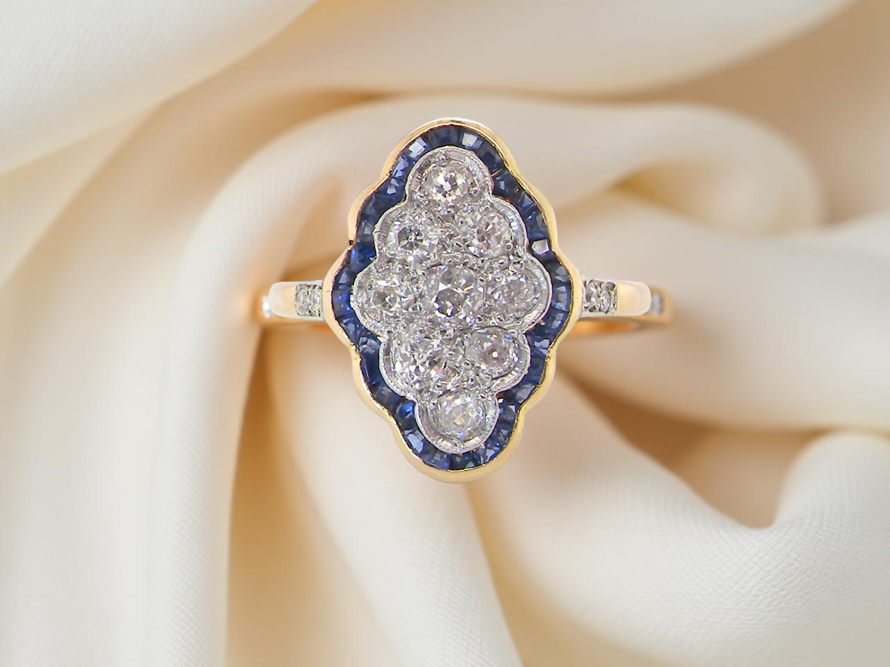 An Art Deco sapphire and diamond cluster ring