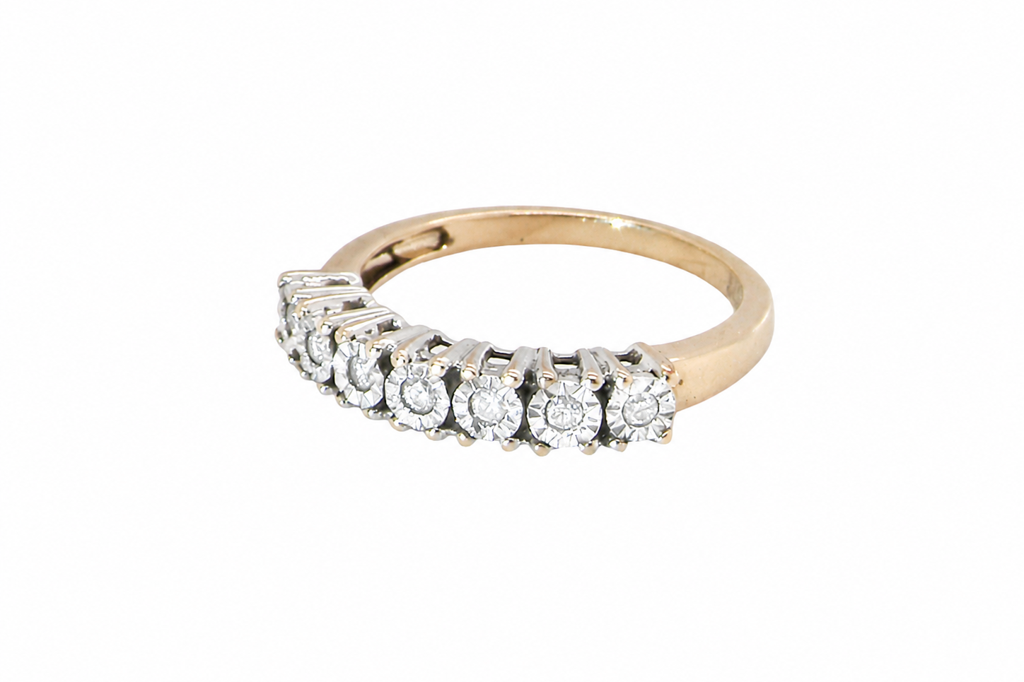 9 carat gold eternity ring.
Set with seven small white diamonds, each 1.8mm within an illusion setting that is 3.8mm in diameter, and white gold. 