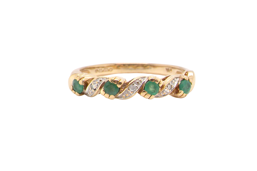 9 carat gold half hoop eternity ring. Set with four 2.4mm emeralds.
Set in alternate sections, a 'lazy S' design,