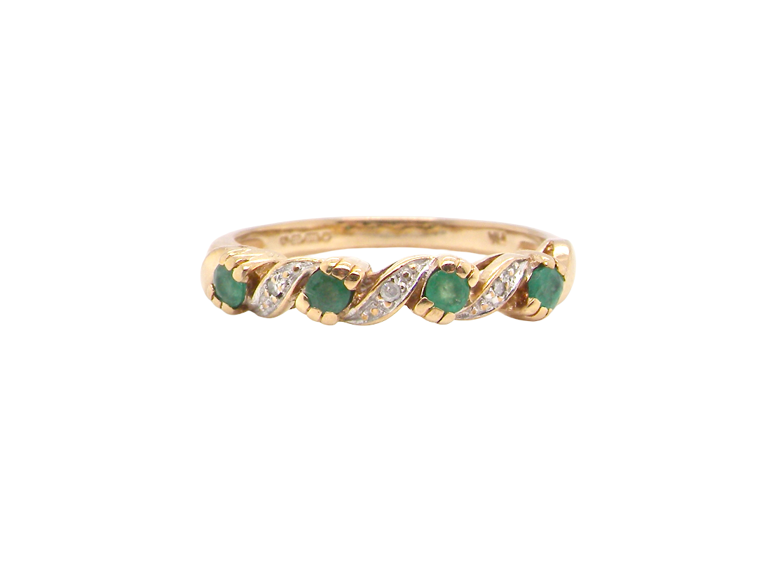 9 carat gold half hoop eternity ring. Set with four 2.4mm emeralds.
Set in alternate sections, a 'lazy S' design,