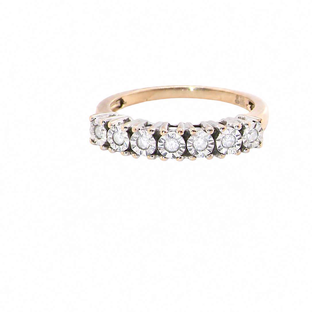 9 carat gold half hoop eternity ring.
Set with seven small white diamonds, each 1.8mm within an illusion setting that is 3.8mm in diameter, and white