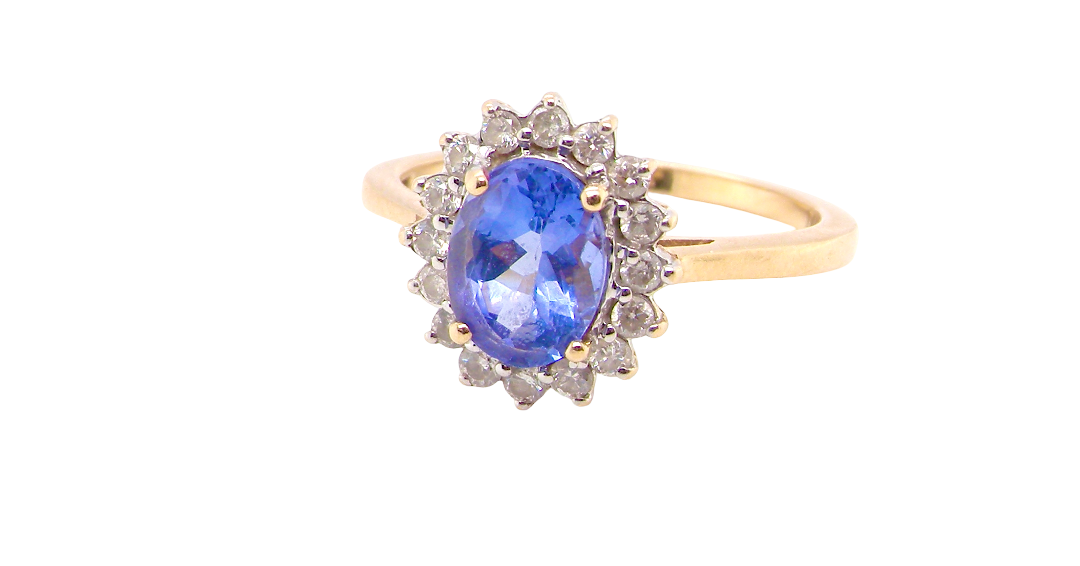 A 14 carat gold cluster ring. Features to the centre an oval cut cornflower blue sapphire, 8x6mm (, four claw setting.
