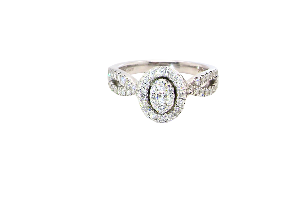 A 14 carat white gold cluster ring. The centre cluster an oval setting with nine small white diamonds.
Around the outside a halo of sixteen smaller diamonds,