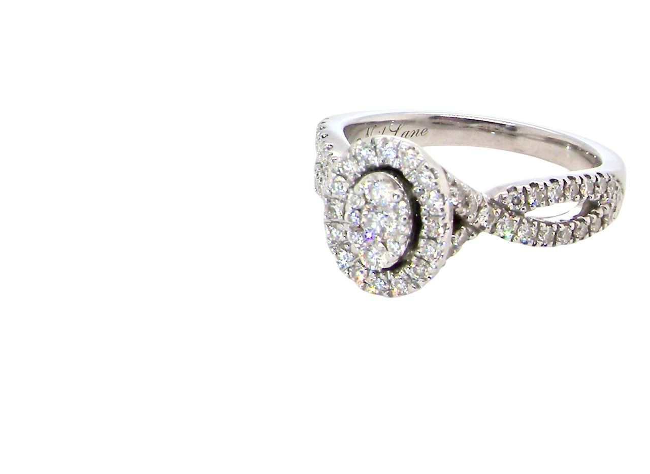 A 14 carat white gold cluster ring. The centre cluster an oval setting with nine small white diamonds.
Around the outside a halo of sixteen smaller diamonds, side