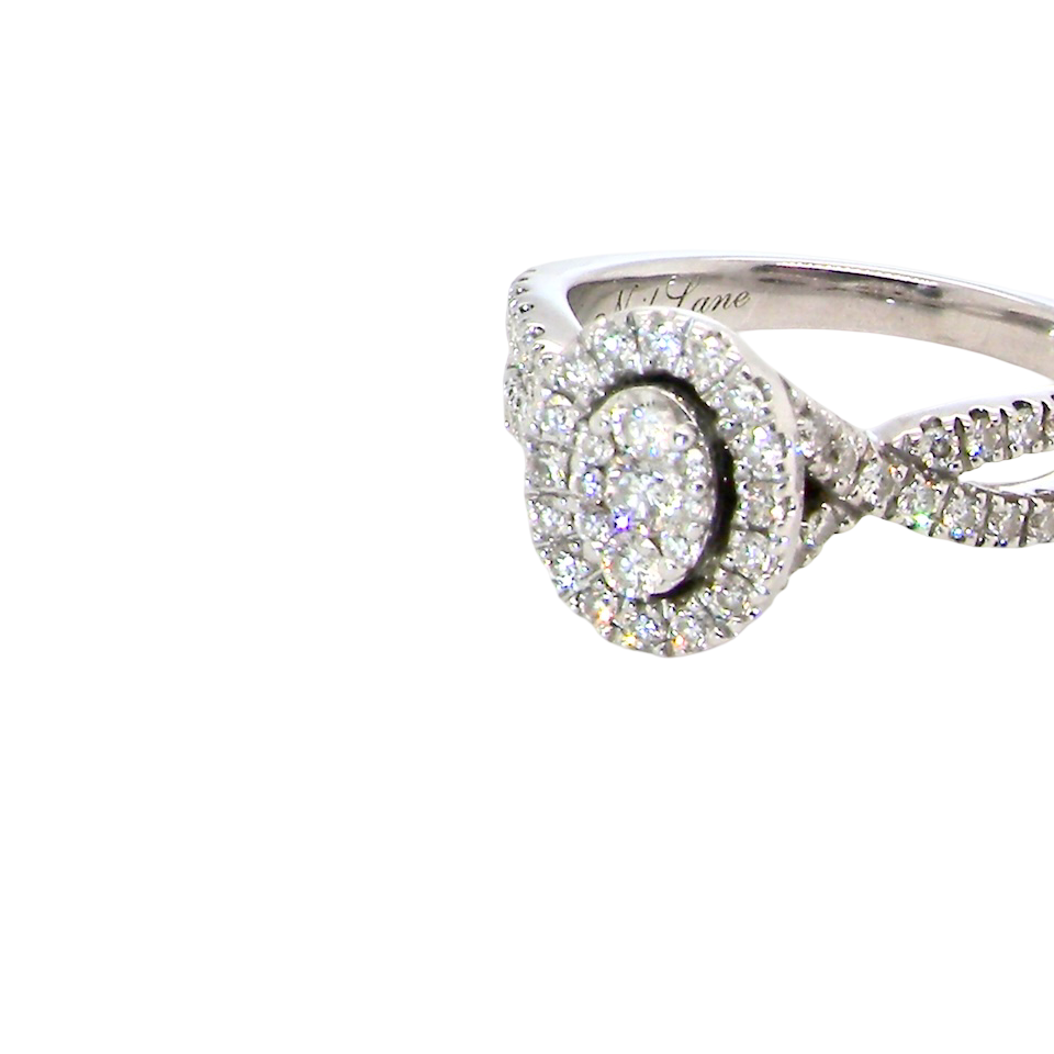 A 14 carat white gold cluster ring. The centre cluster an oval setting with nine small white diamonds.
Around the outside a halo of sixteen smaller diamonds, side