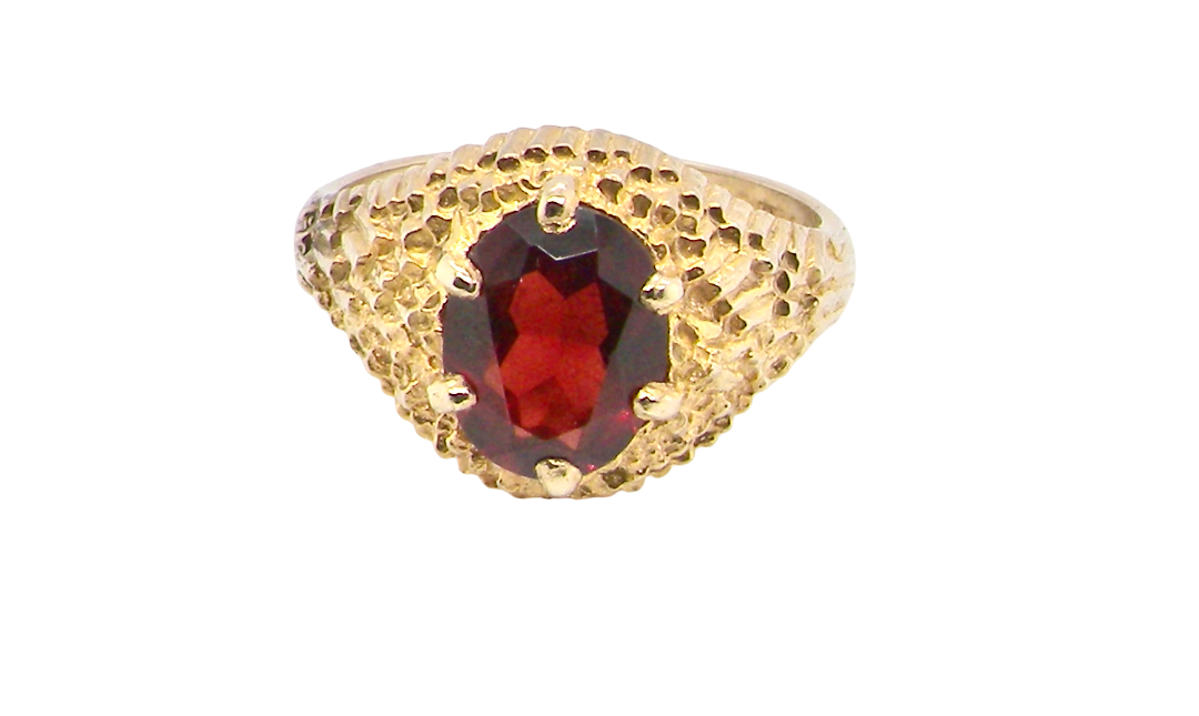 A 1970s dress ring set with an oval garnet stone. This measures 10x8mm