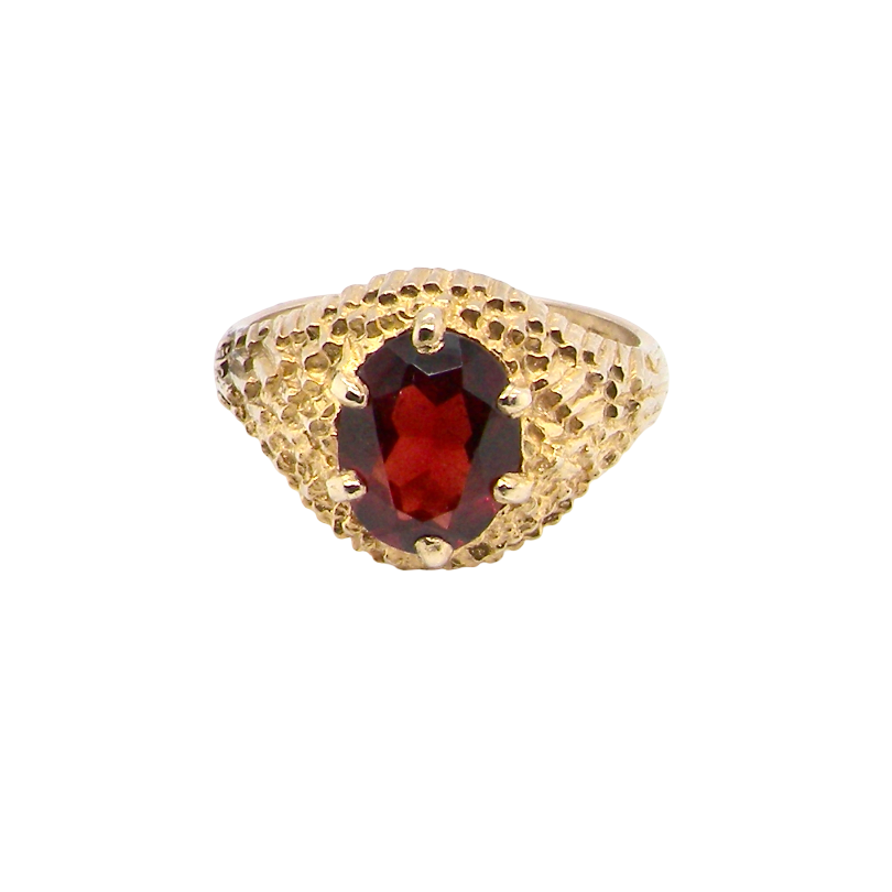 A 1970s dress ring set with an oval garnet stone. This measures 10x8mm and claw set.