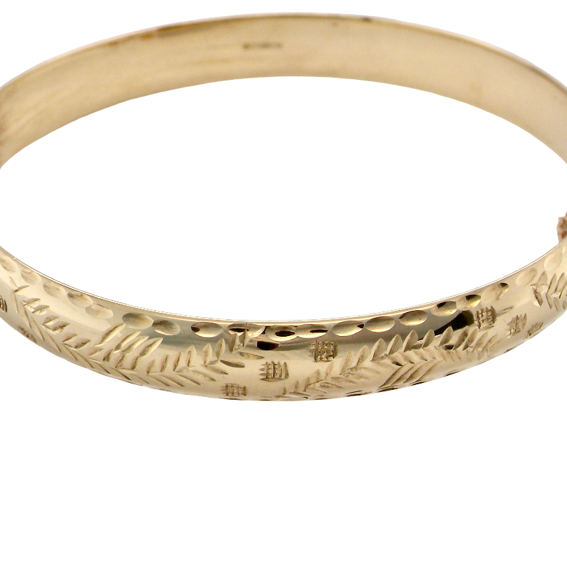 A vintage gold bangle bracelet with engraved leaf patterns and a hammered texture, shown on a plain white background.