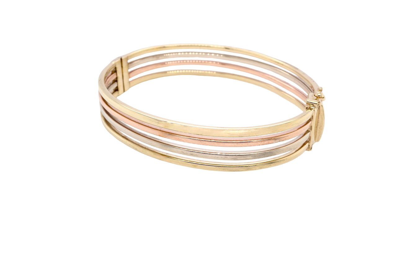 A 9 carat gold bangle. Solid bands of rose, yellow and white gold
