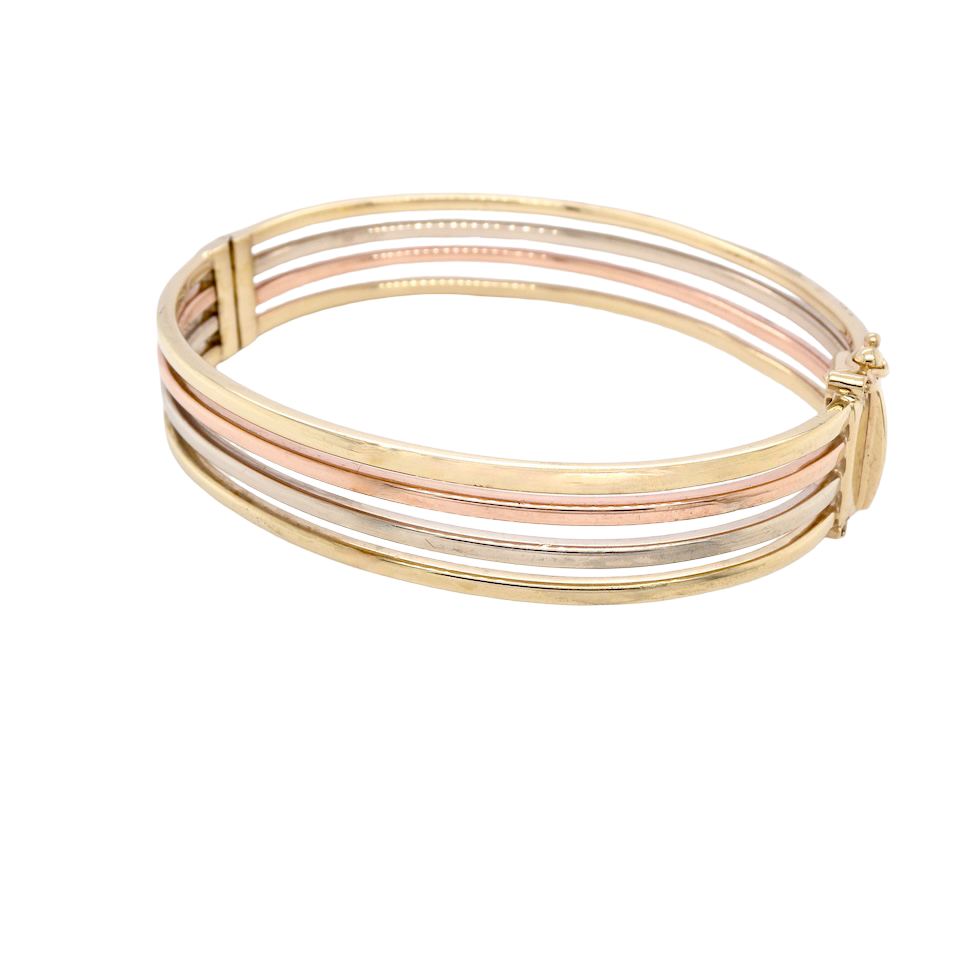 A 9 carat gold bangle. Solid bands of rose, yellow and white gold