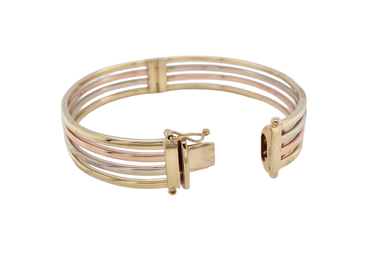 A 9 carat gold bangle. Solid bands of rose, yellow and white gold 9 carat