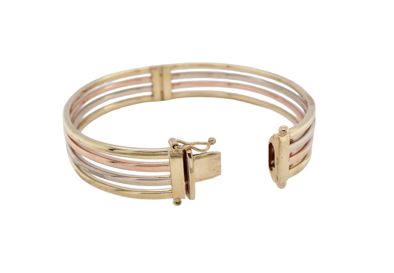 A 9 carat gold bangle. Solid bands of rose, yellow and white gold 9 carat