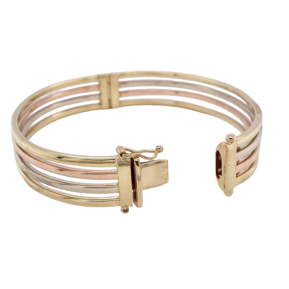 A 9 carat gold bangle. Solid bands of rose, yellow and white gold 9 carat