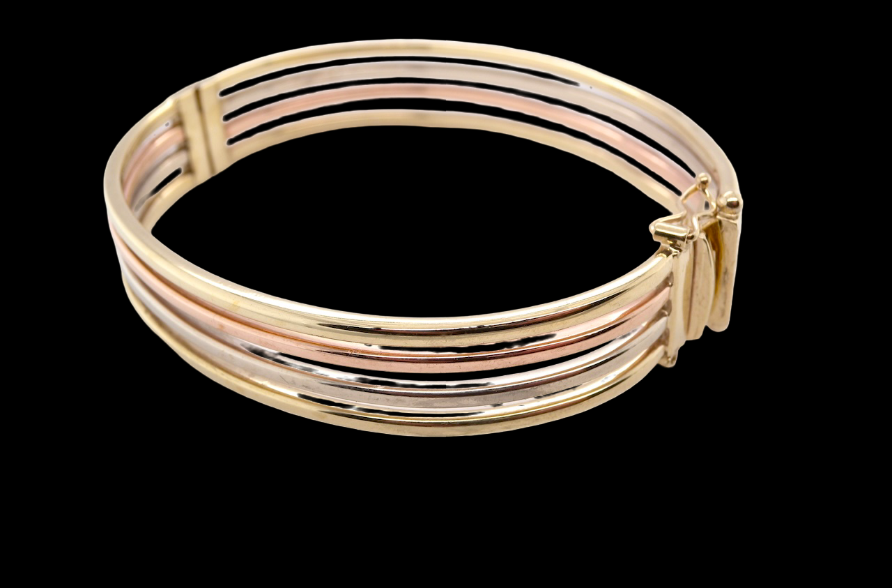 A 9 carat gold bangle with bands of rose, yellow and white gold