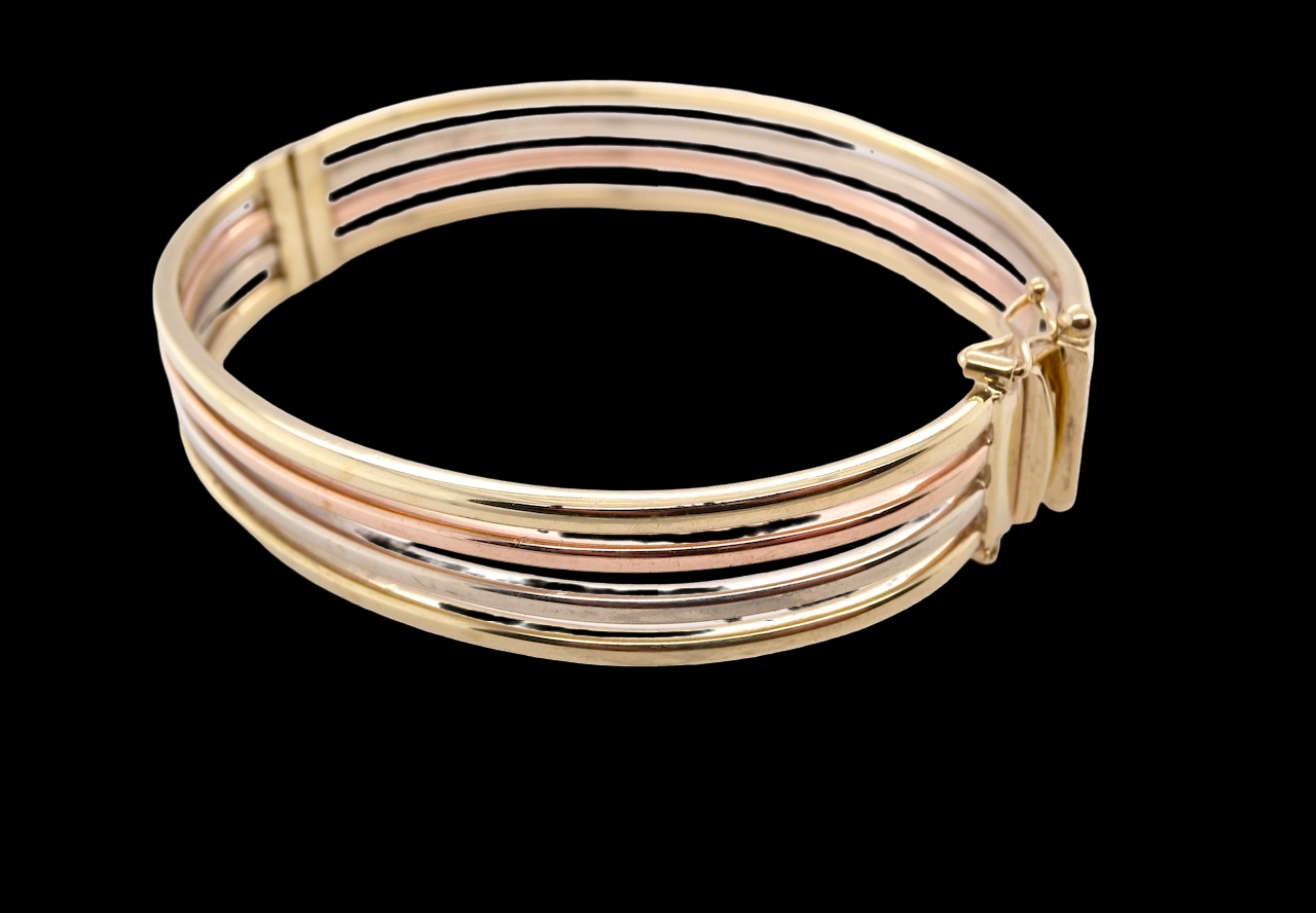 A 9 carat gold bangle with bands of rose, yellow and white gold