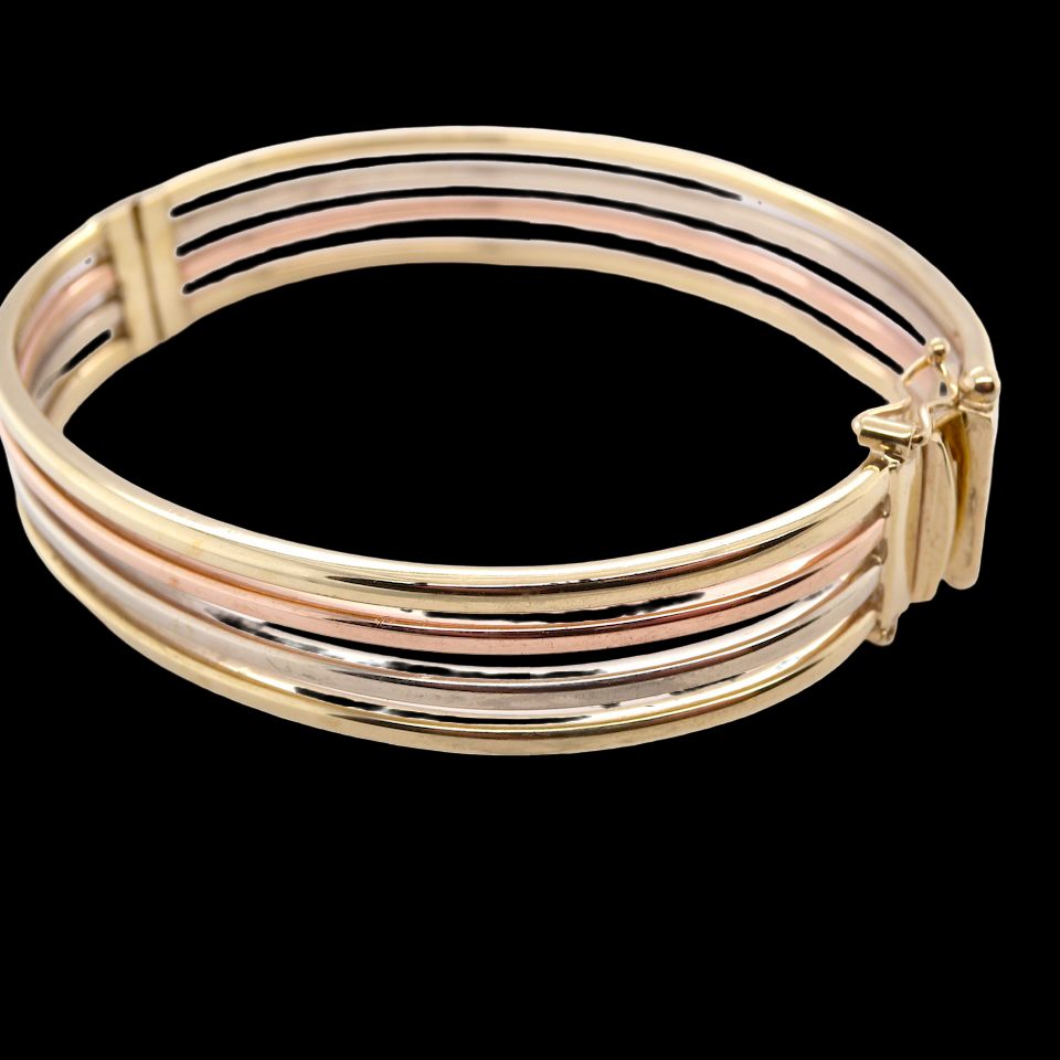 A 9 carat gold bangle with bands of rose, yellow and white gold