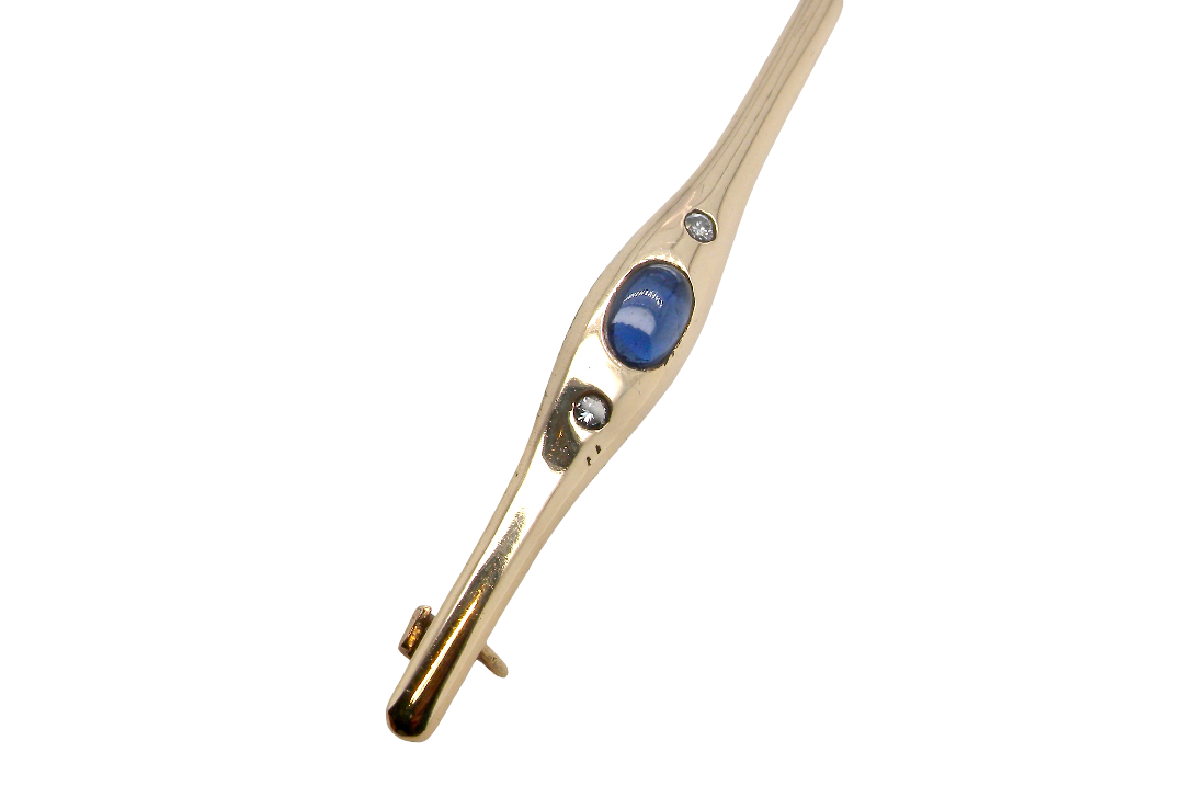 A 9 carat gold bar brooch, width 55mm. Set with a cabouchon cut sapphire,