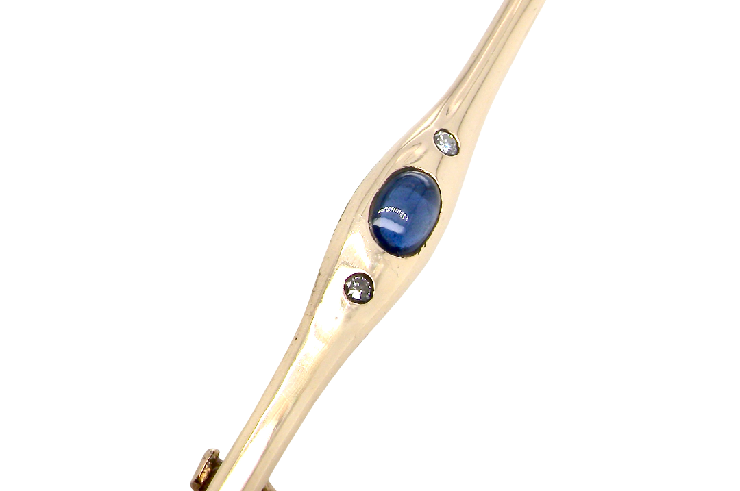 A 9 carat gold bar brooch, width 55mm. Set with a sapphire,