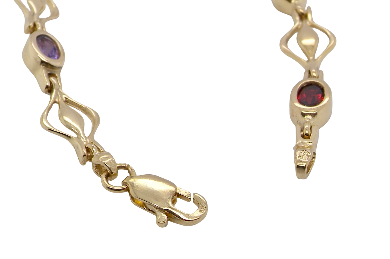 A 9 carat gold bracelet. Set with various gemstones,