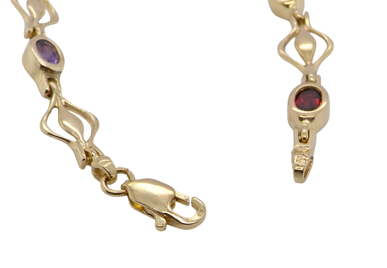 A 9 carat gold bracelet. Set with various gemstones,