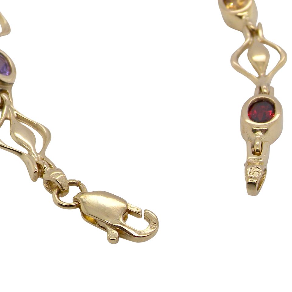 A 9 carat gold bracelet. Set with various gemstones,