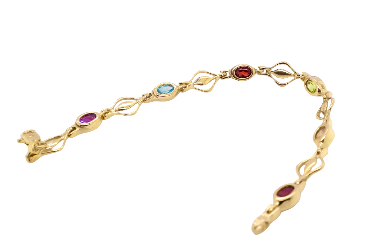A 9 carat gold bracelet. Set with various gemstones, all oval cut.