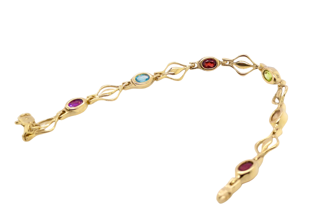 A 9 carat gold bracelet. Set with various gemstones, all oval cut.