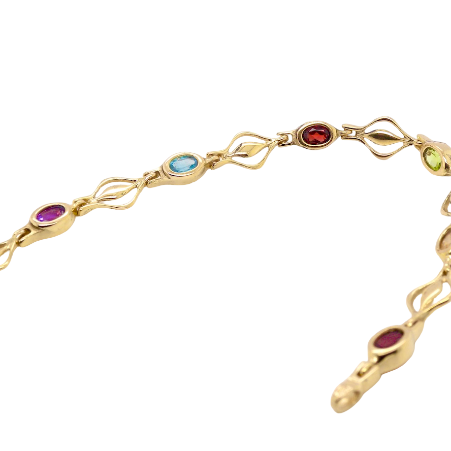 A 9 carat gold bracelet. Set with various gemstones, all oval cut.