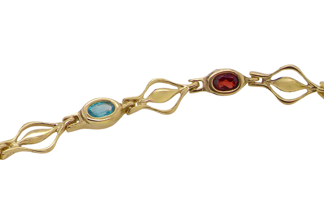 A 9 carat gold bracelet. Set with various gemstones, all oval cut. close up