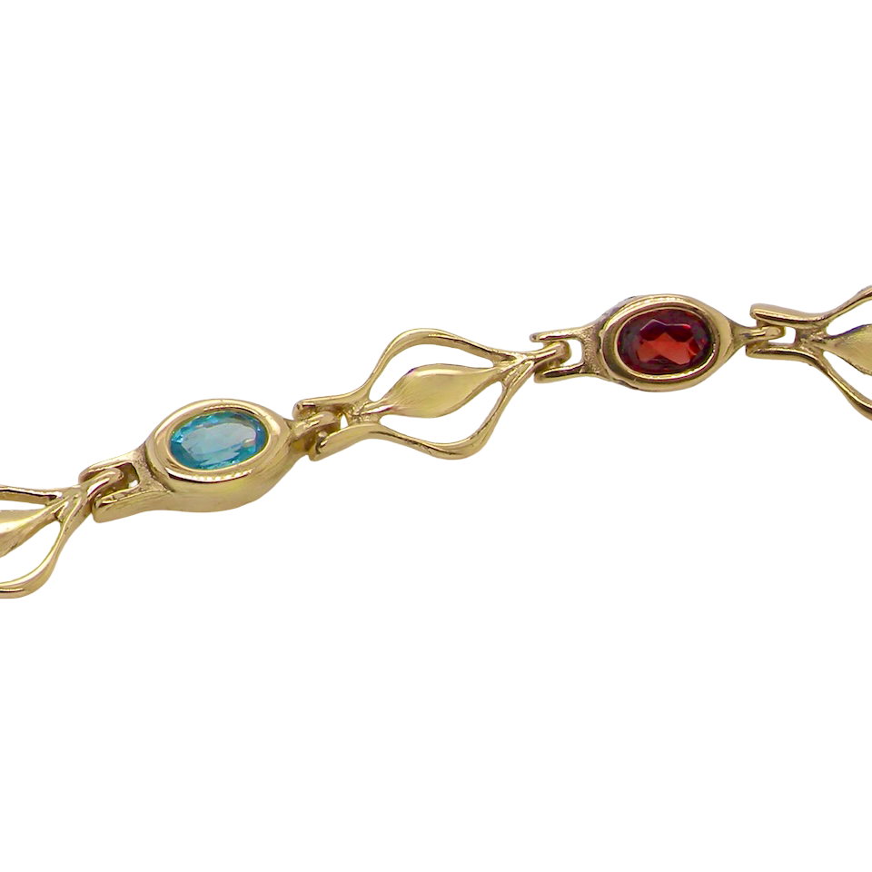 A 9 carat gold bracelet. Set with various gemstones, all oval cut. close up
