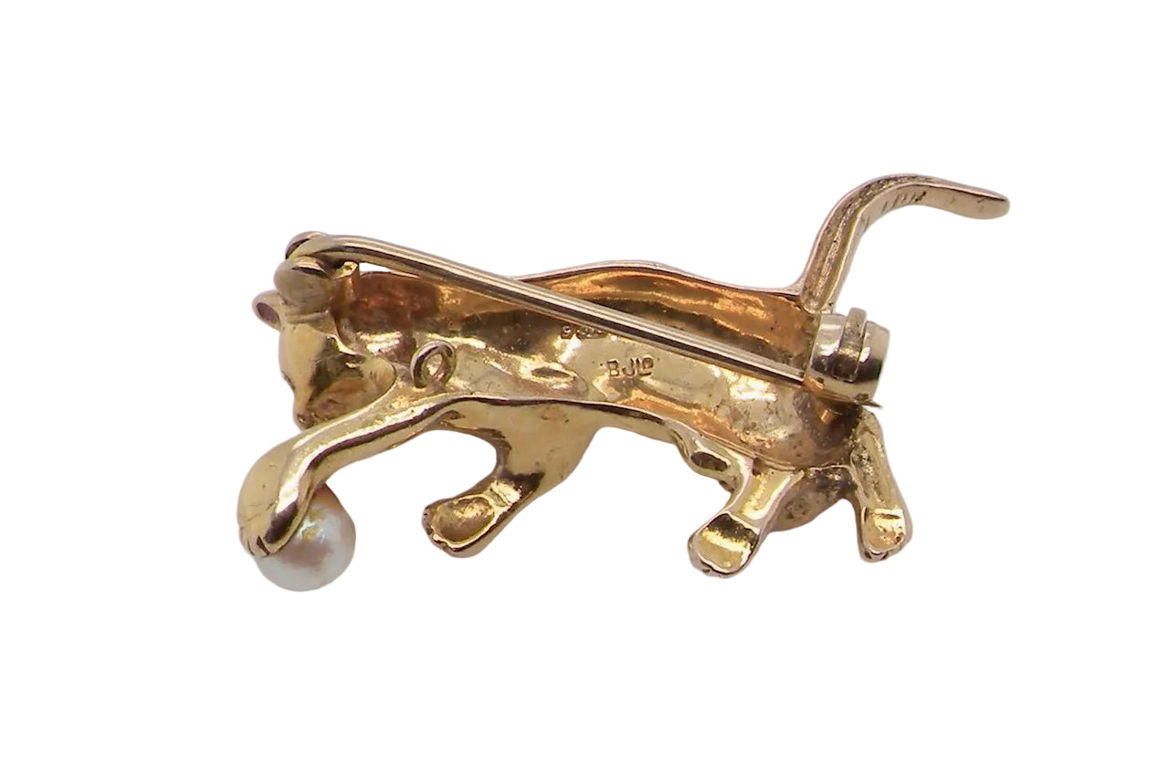 A 9 carat gold brooch in the shape of a cat chasing a ball. Rear