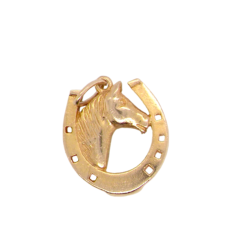 A 9 carat gold charm in the shape of a horseshoe with a horses head profile to the centre.