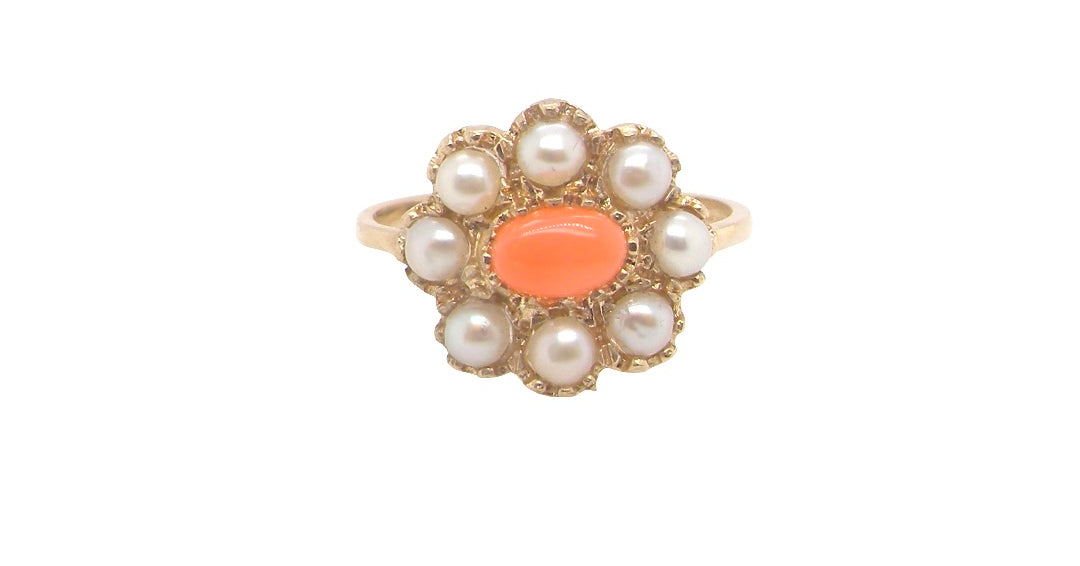 A 9 carat gold cluster ring. Centre stone an oval shaped coral stone 6x4mm.