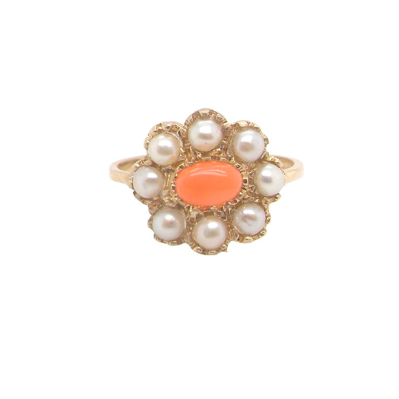 A 9 carat gold cluster ring. Centre stone an oval shaped coral stone 6x4mm.