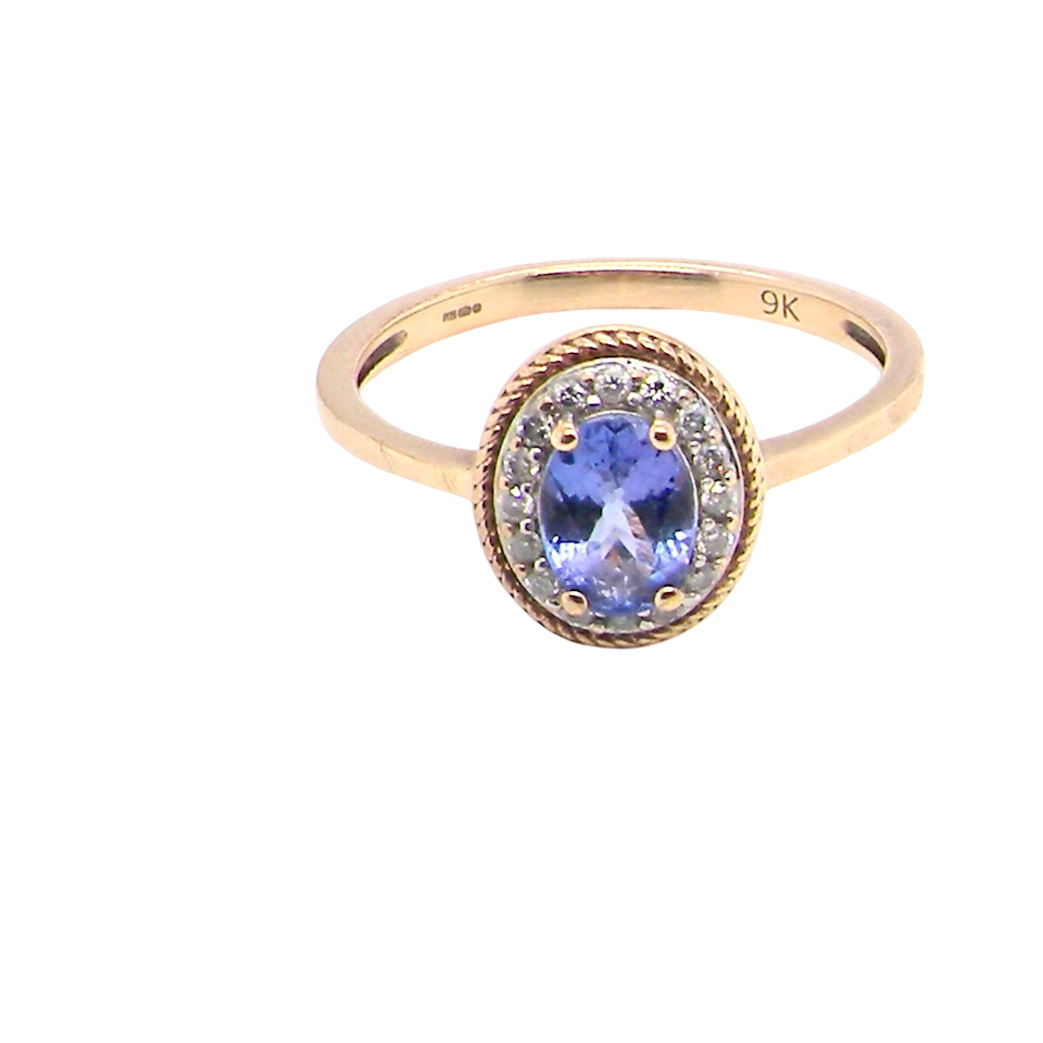 A 9 carat gold cluster ring. Features to the centre an oval cut tanzanite gem stone. Measures 7x5mm,