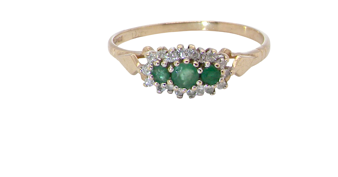 A 9 carat gold cluster ring. Set to the centre three round emeralds, centre 3.2mm,
