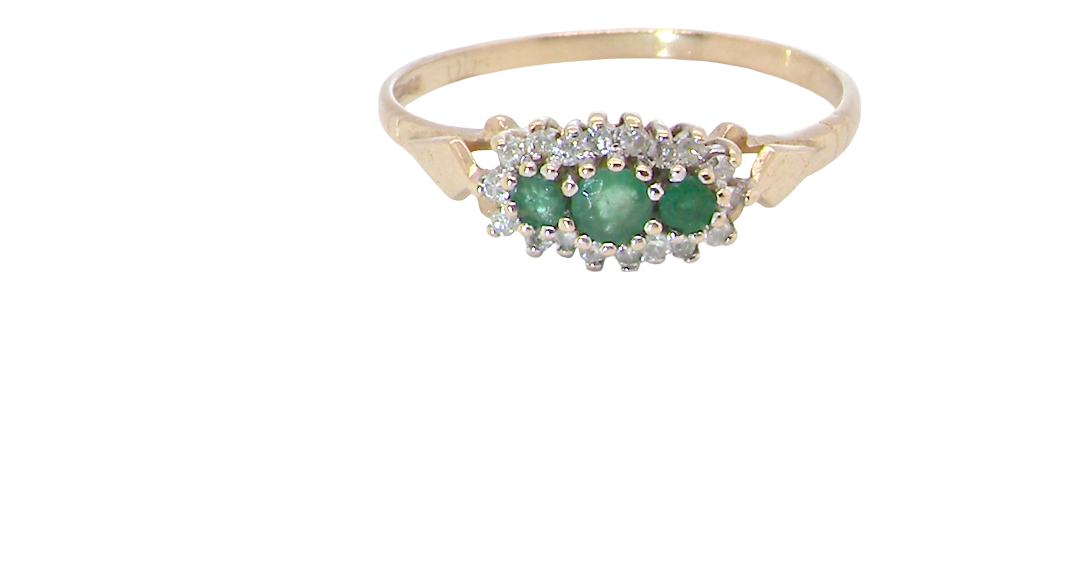 A 9 carat gold cluster ring. Set to the centre three round emeralds, centre 3.2mm, each side a 2.6mm stone.
