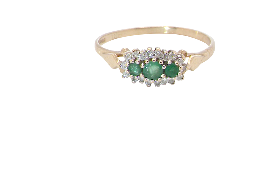 A 9 carat gold cluster ring. Set to the centre three round emeralds, centre 3.2mm, each side a 2.6mm stone.