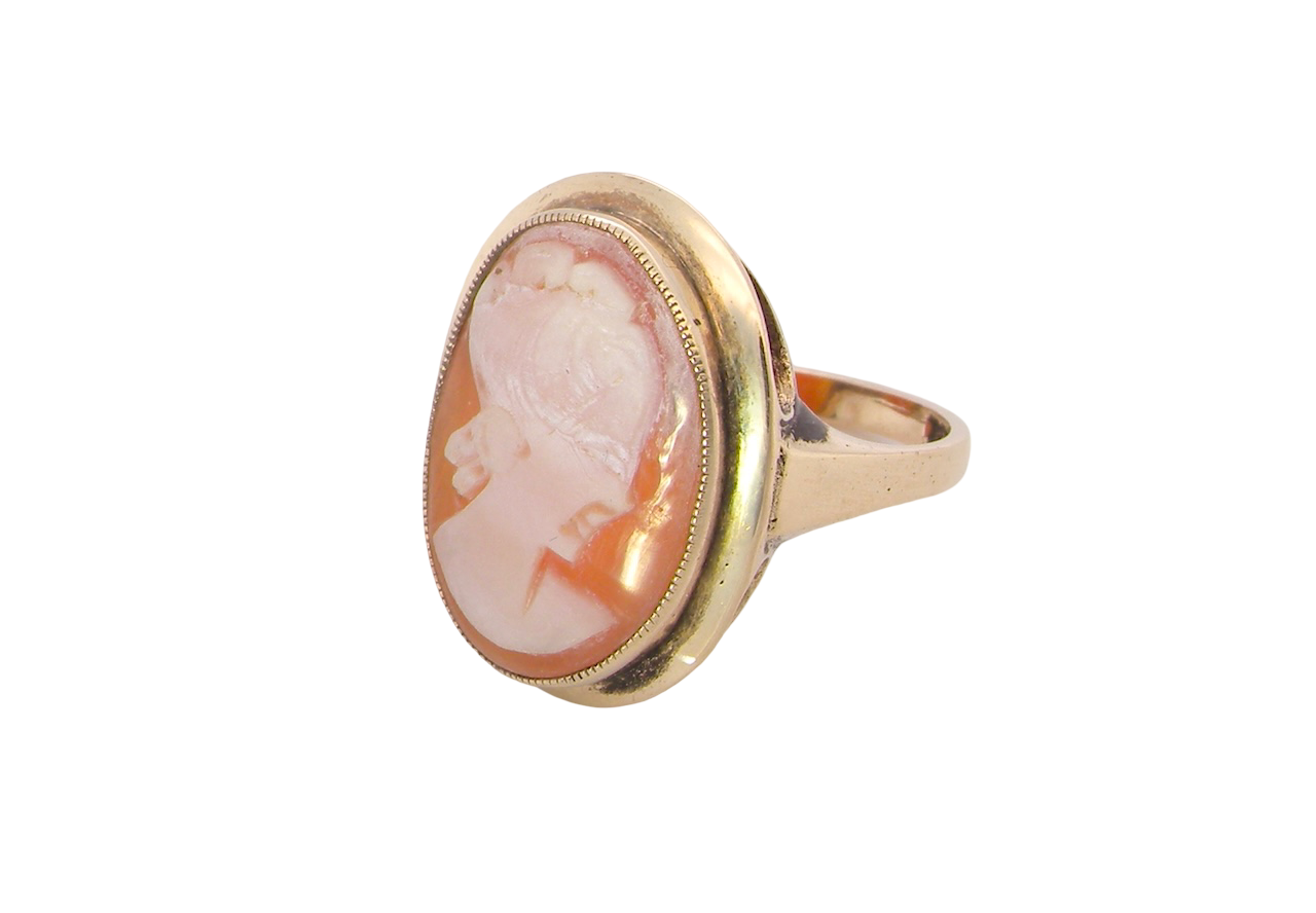A 9 carat gold dress ring that features a cameo shell. Carved with the head of a young woman.