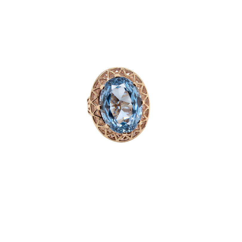An oval ring featuring a light blue marquise-cut gemstone in a textured rose gold setting, shown against a plain white background.