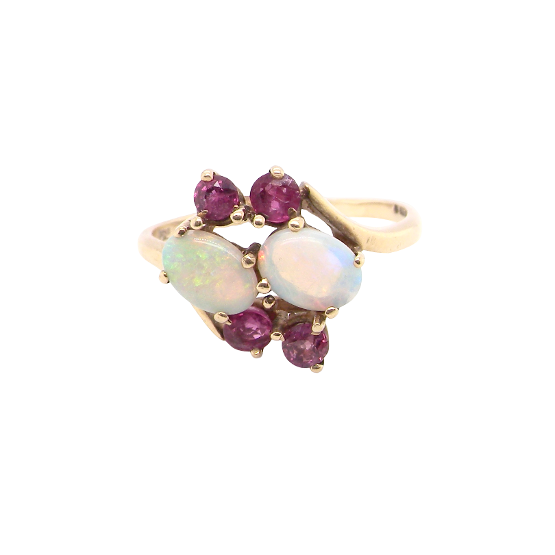 A 9 carat gold dress ring that features two oval white opals, each 7x5mm, and four rubies