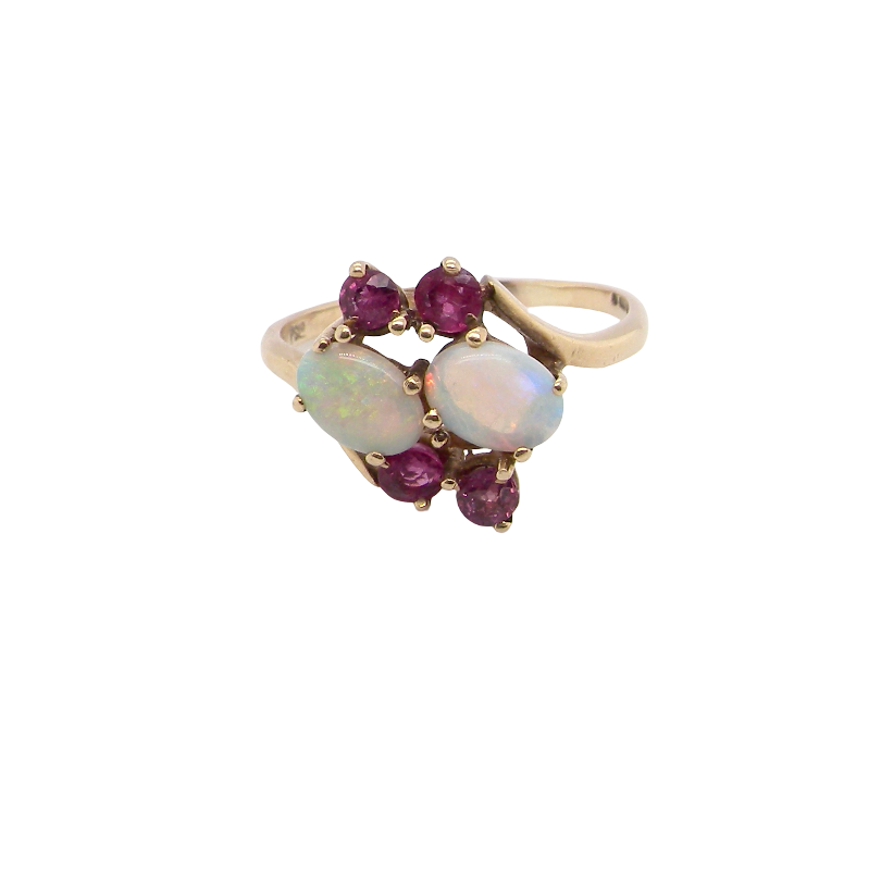 A 9 carat gold dress ring that features two oval white opals, each 7x5mm, and four rubies each 3.4mm.