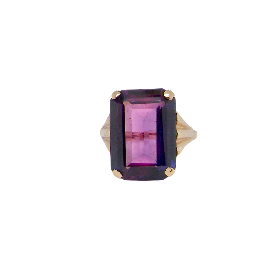 A 9 carat gold* dress ring that is set with a substantial amethyst gemstone.