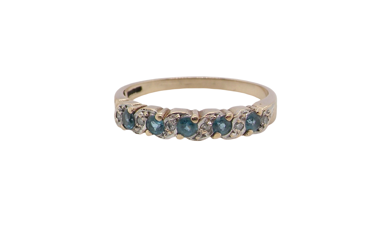 A 9 carat gold half hoop eternity ring. Set with five blue topaz gem stones, each 2.8mm. 