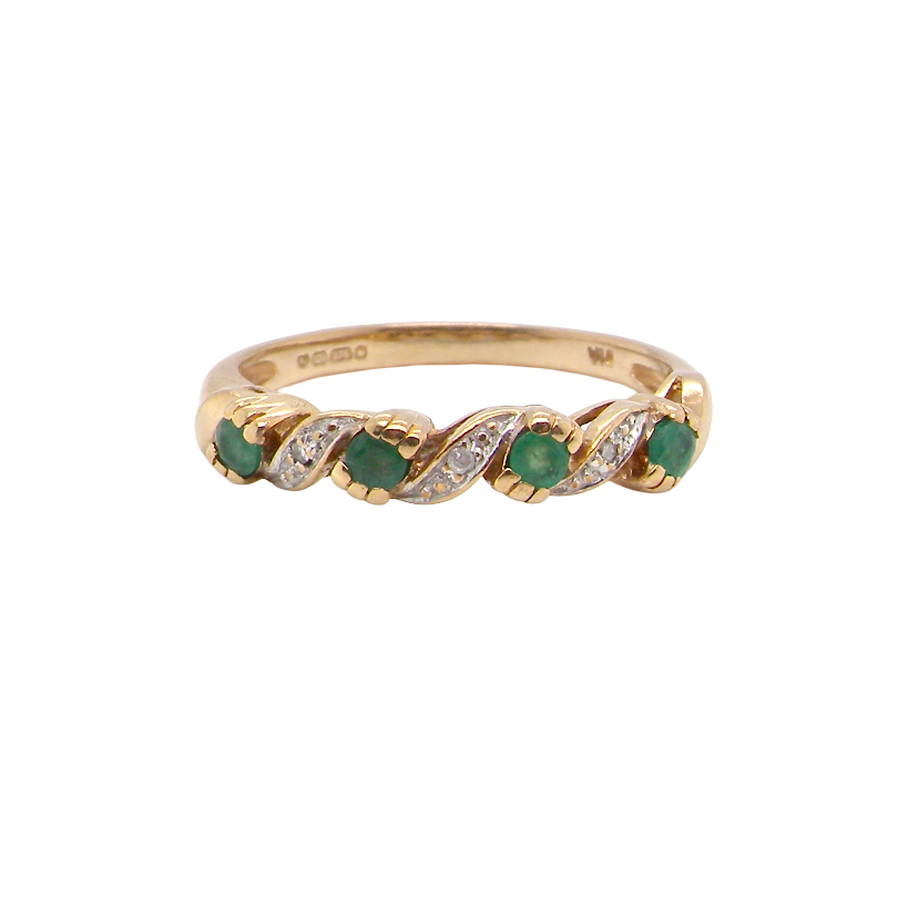 A 9 carat gold half hoop eternity ring. Set with four 2.4mm emeralds.
Set in alternate sections, a 'lazy S' design,